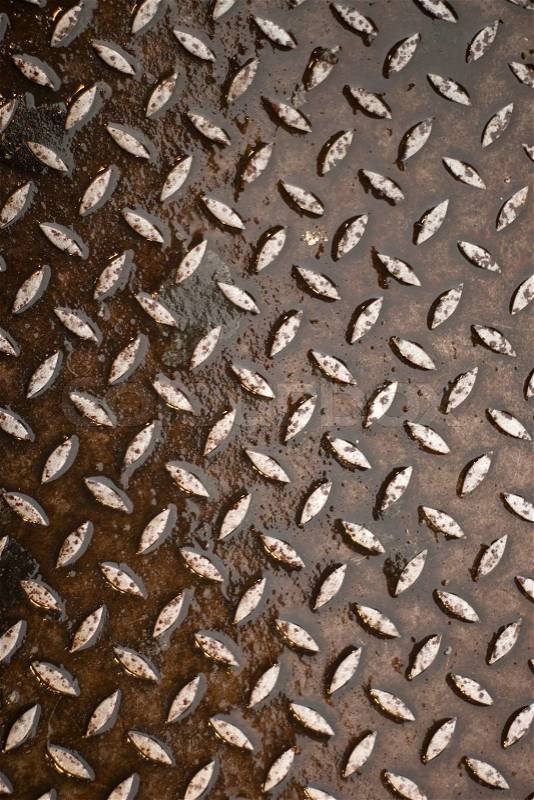 Closeup of real diamond plate material. Wet and rusty. This is a photo not an illustration, stock photo