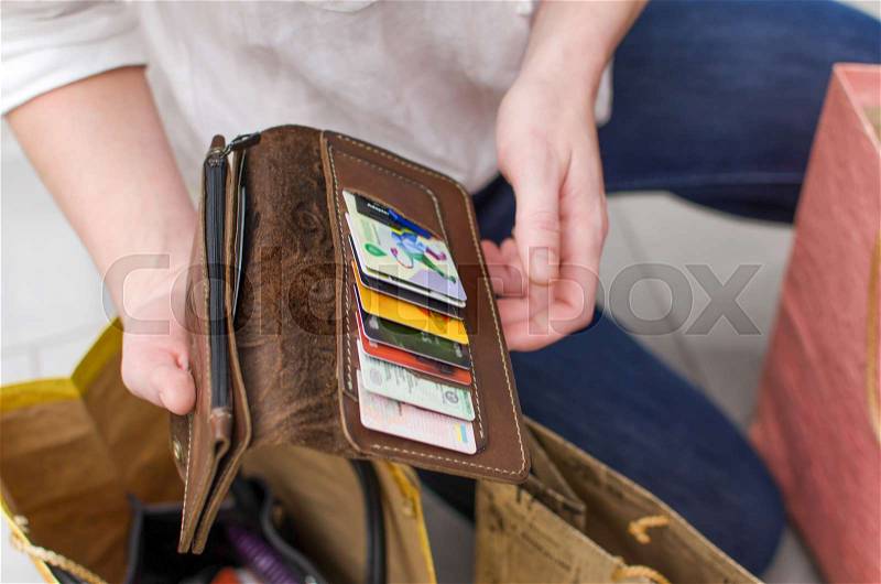 Young woman with a purse in the supermarket, stock photo