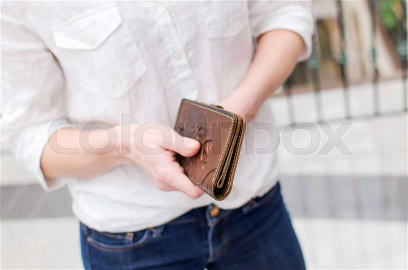 Young woman with a purse in the supermarket, stock photo