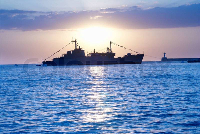 Lonely military ship against blue marine sunset, stock photo