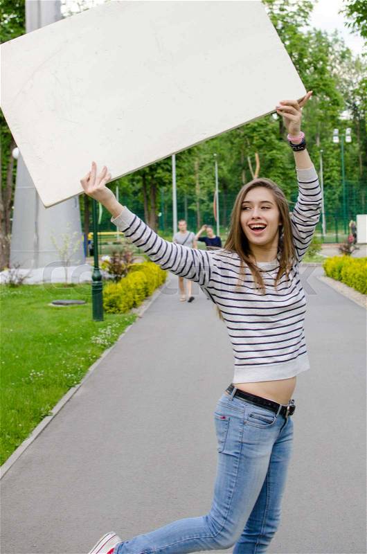 Young girl with the white banner in the city, stock photo