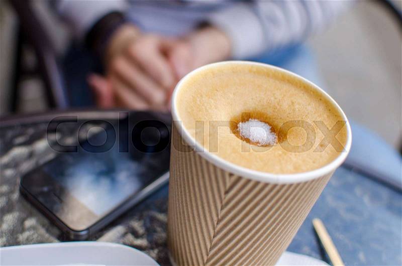 Young woman with tasty coffee on the street, stock photo