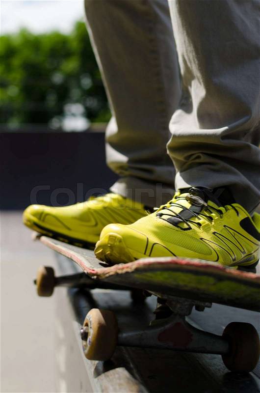 Young man with skateboard in the park, stock photo