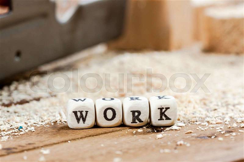 Word WORK written on a wooden block. Work tools concept, stock photo
