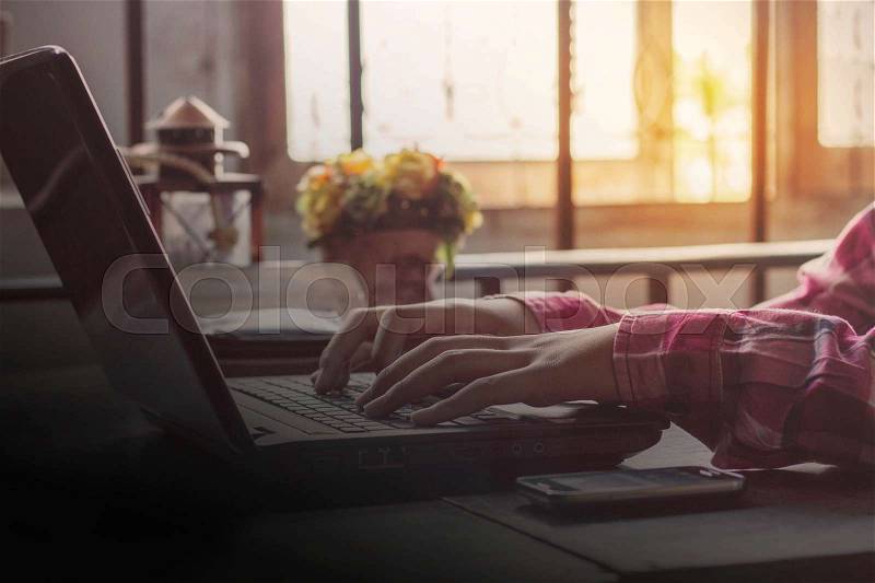 People are typing on the computer at the old table, stock photo