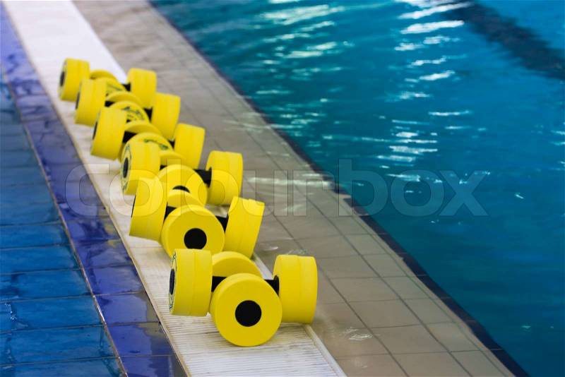 Sports equipment for aqua aerobics in the pool, stock photo