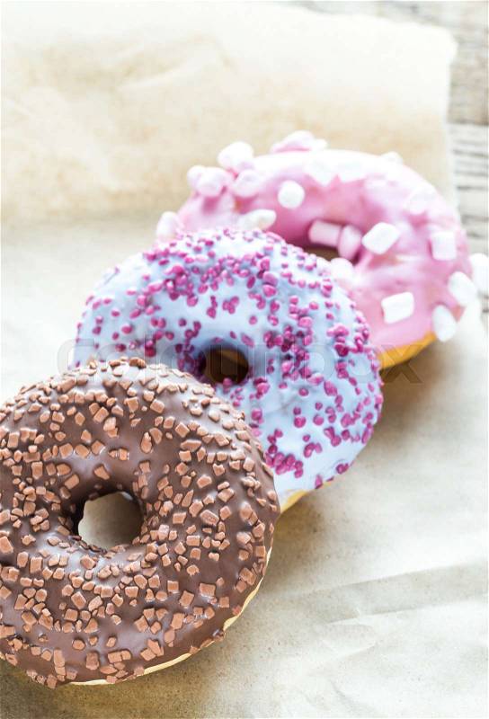 Colourful donuts on the baking paper, stock photo