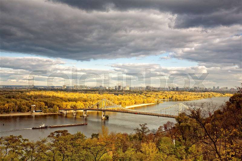 Panoramic urban landscape with river and bridge, seasonal view, stock photo