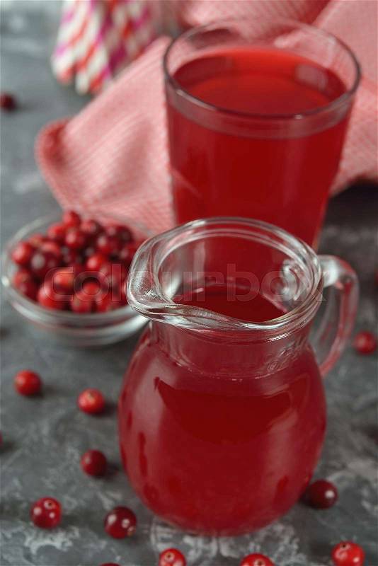 Fresh cranberry juice on a gray background, stock photo