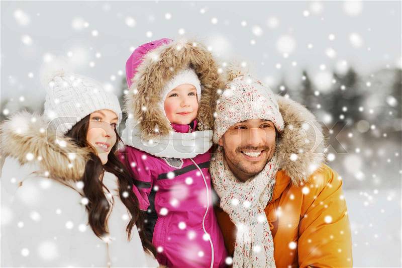 Parenthood, fashion, season and people concept - happy family with child in winter clothes outdoors, stock photo