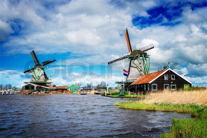 Two traditional Dutch windmills of Zaanse Schans, Netherlands, retro toned, stock photo