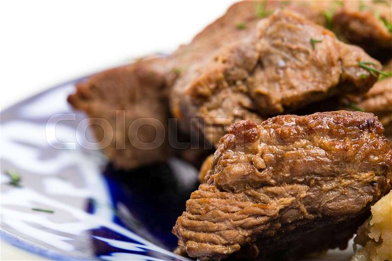 Delicious baked lamb racks with vegetable garnish and minced dill. Macro. Photo can be used as a whole background, stock photo