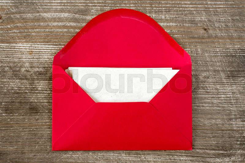 Opened red envelope with blank letter on wooden desk, stock photo