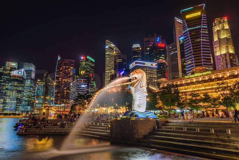 SINGAPORE-JULY 8, 2016: Merlion statue fountain in Merlion Park and Singapore city skyline at night on July 8, 2016. Merlion fountain is one of the most famous tourist attraction in Singapore, stock photo