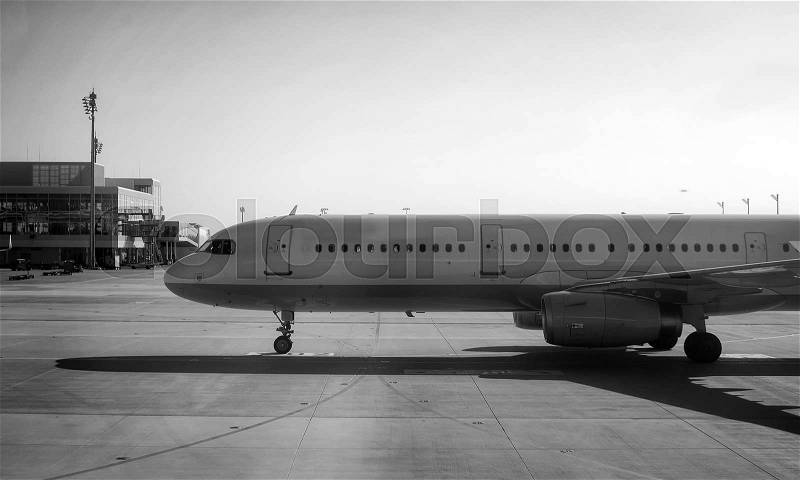 Passenger plane heading to the airport. Black and white, stock photo