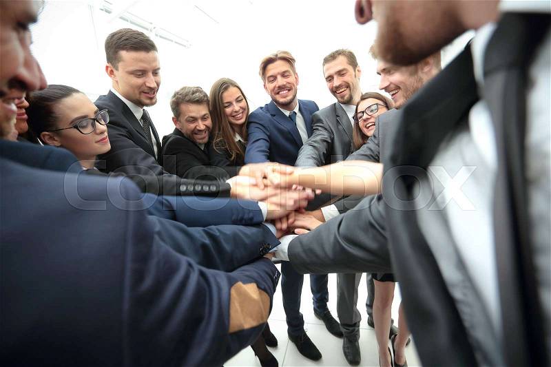 Large successfull business team showing unity with their hands together, stock photo