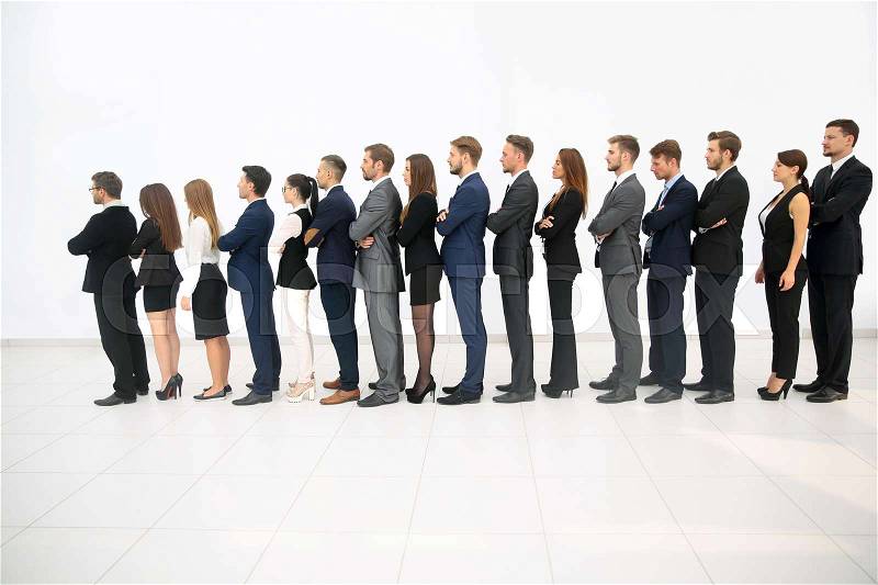 Smiling business people standing together in line in a modern of, stock photo