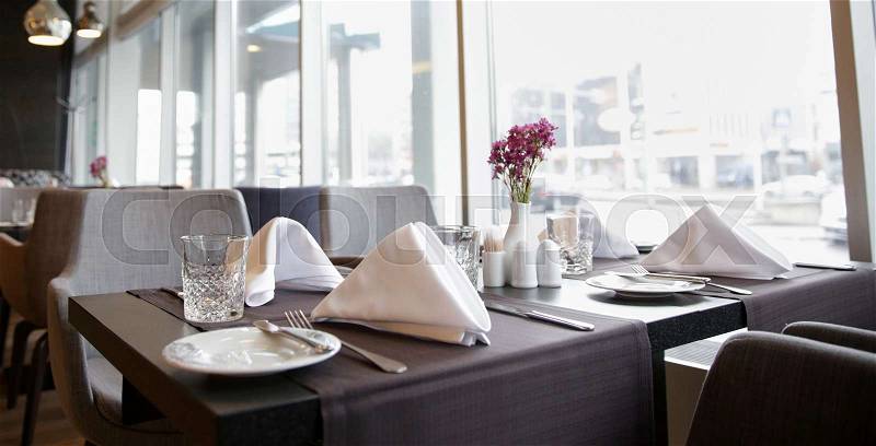 Public place, table setting and interior concept - restaurant interior with tables and chairs, stock photo