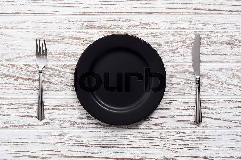 Empty plate fork knife silverware white wooden table background still life vintage flat lay, stock photo