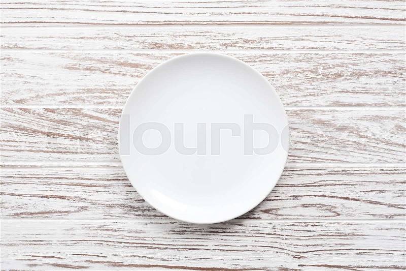 Empty plate on white wooden table background still life vintage flat lay, stock photo