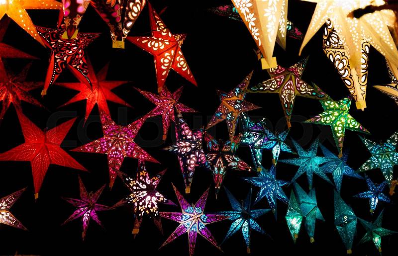 Colorful Christmas stars. A background of star lanterns, stock photo