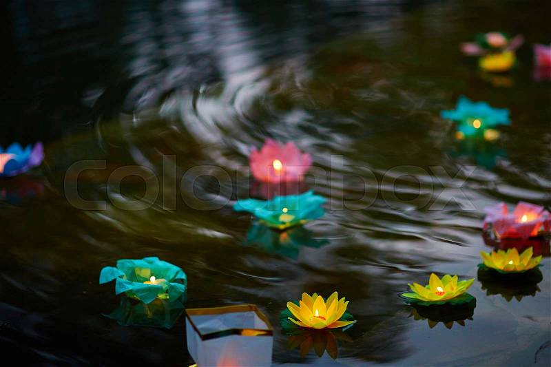 Paper flower lanterns in water at floating lantern festival, stock photo