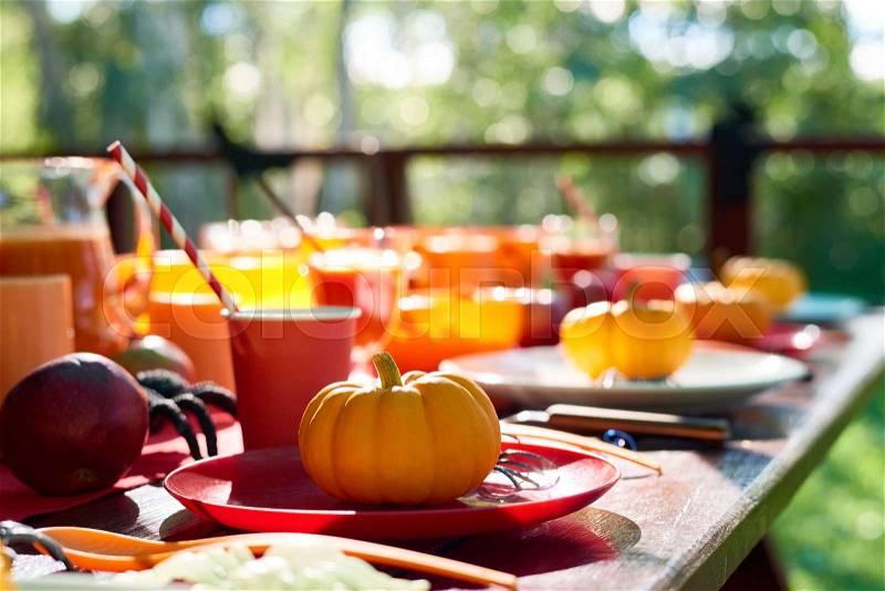 Close-up of table decorated with pumpkins and spiders, stock photo