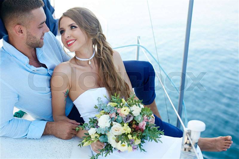 Happy young newlyweds enjoying romantic voyage, stock photo