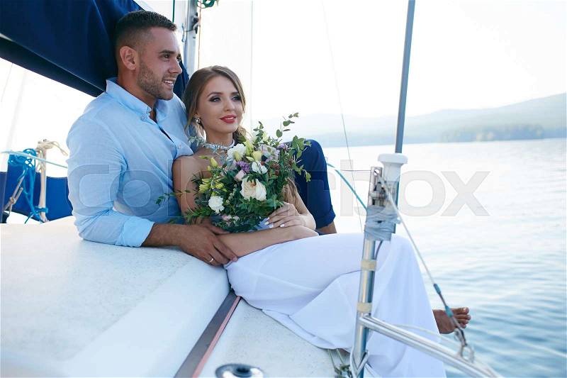 Just married couple traveling by sea on yacht, stock photo