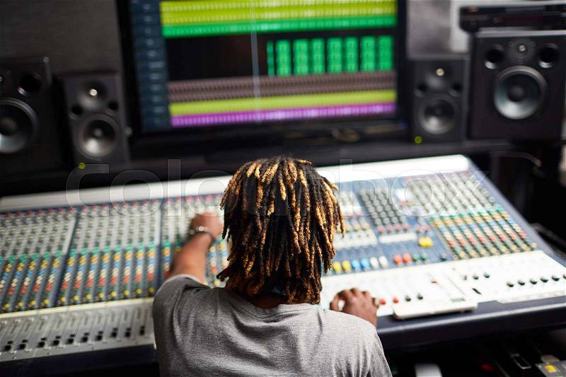 Back view of modern sound record operator at work, stock photo