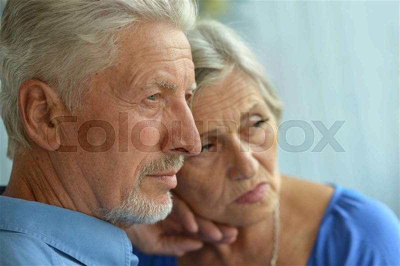 Portrait of a sad senior couple at home, stock photo