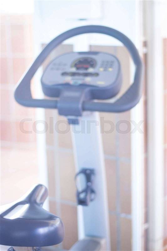 Gym bike exercise cycle machine for static indoor cycling in fitness and aerobic studio, stock photo
