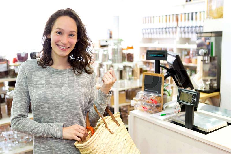 View of a Young attractive woman shooping looses spices at the grocery, stock photo