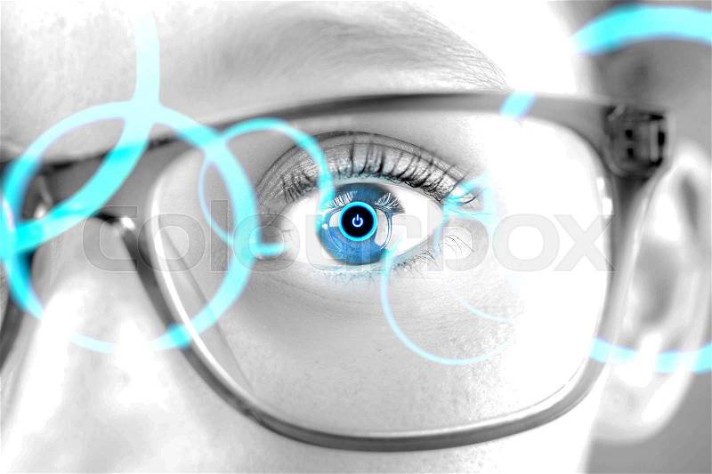 Detailed close up view of an brown eye behind glasses in high definition, stock photo