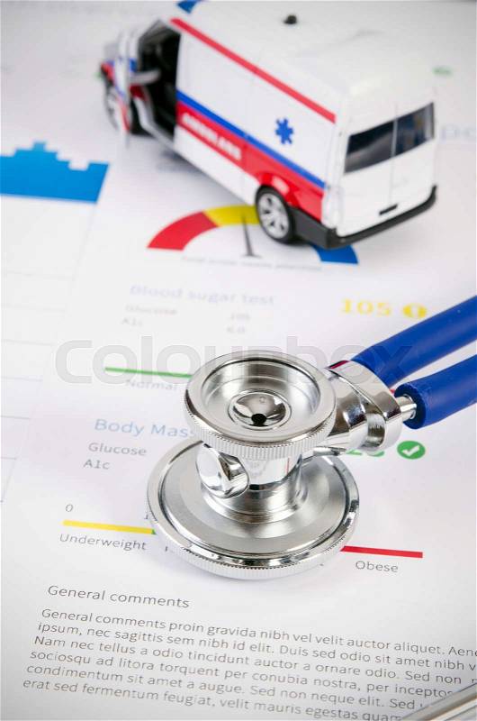 Health condition score report. Stethoscope on medical background with ambulance toy composition, stock photo