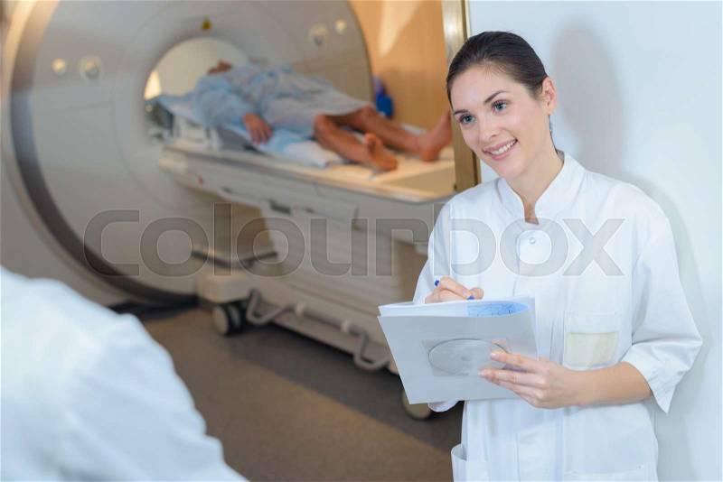 Nurse at entrance to scanning room, stock photo