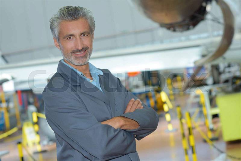 Portrait of an aviation engineer in a hangar, stock photo