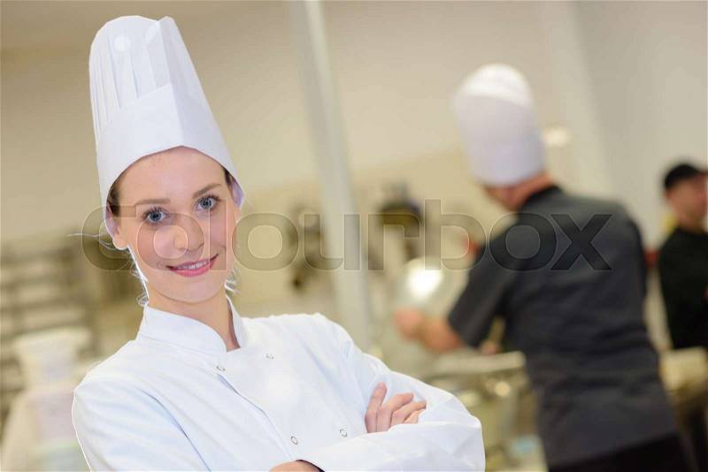 Young woman in white chef dress with hat, stock photo