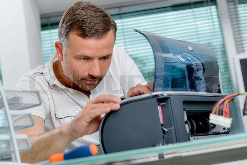 Man repairing printer, stock photo
