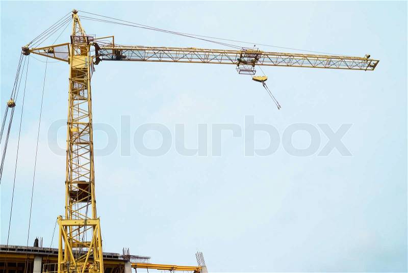 Building crane with the blue sky background, stock photo