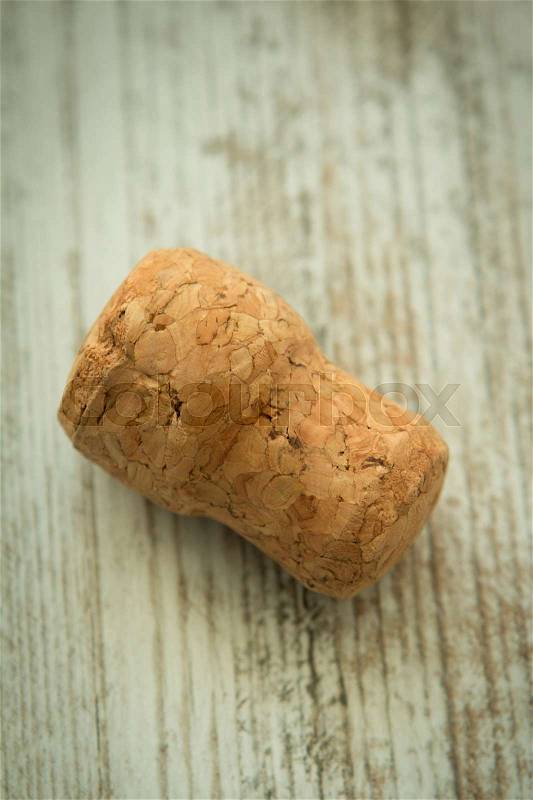 Cork from a champagne bottle on a wooden background worn, stock photo