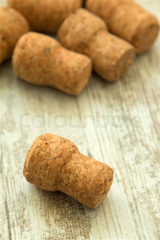 Corks from a champagne bottle on a wooden background worn, stock photo