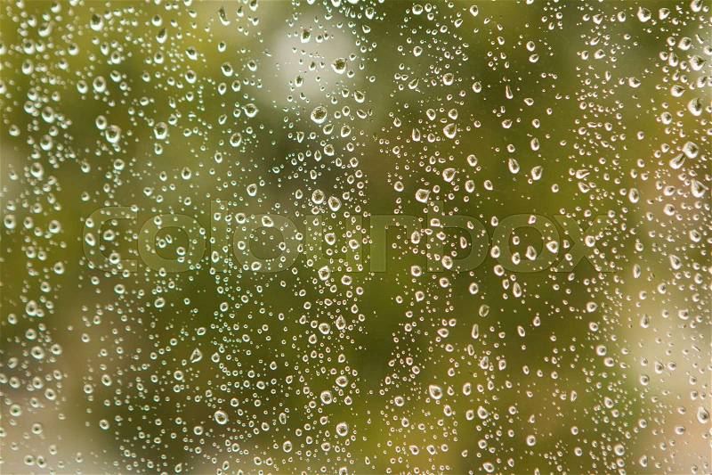 Glass with drops of rain water close up, stock photo