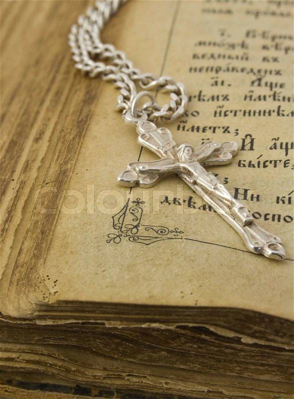 Old bible and silver cross, stock photo