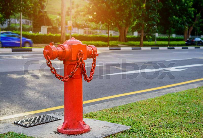 Red fire hydrant water pipe near the road. Fire hidrant for emergency fire access, stock photo