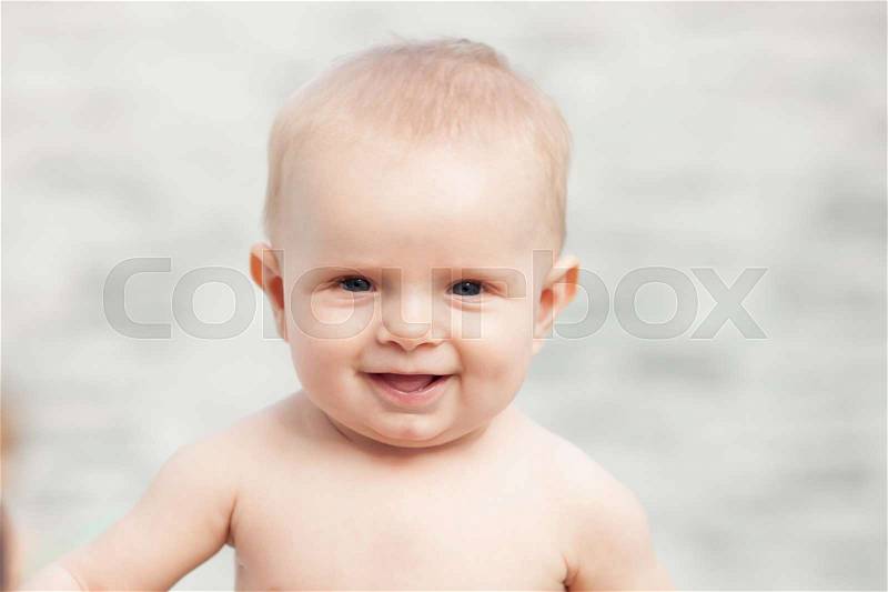 Little baby six month with blue eyes and blond hair gesturing, stock photo