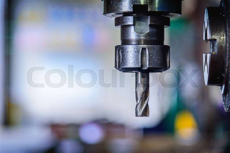 Detail of vertical drilling machine in factory workshop, stock photo