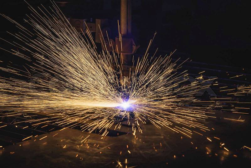 Industrial CNC plasma cutting of metal plate in construction industry, stock photo