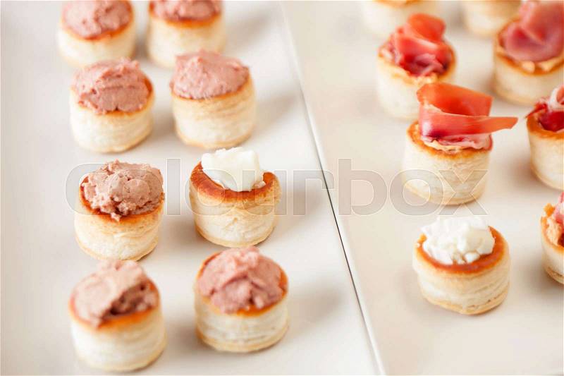 Snacks tasty snacks, assorted canapes cheese, pâté, and ham, stock photo