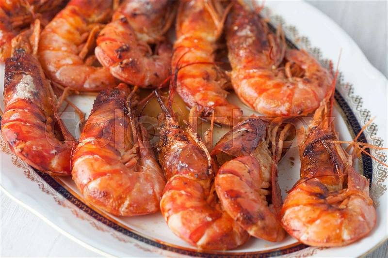 Delicious dish of baked prawns with selective focus, stock photo